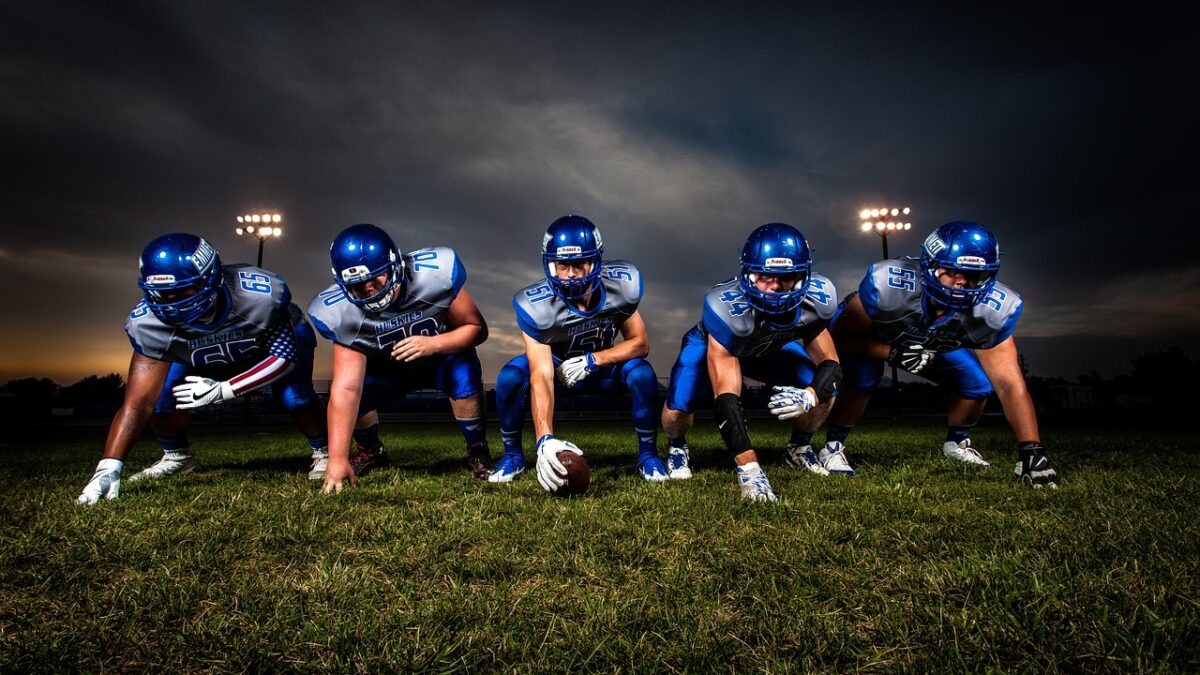 Football team lined up facing camera ready to charge