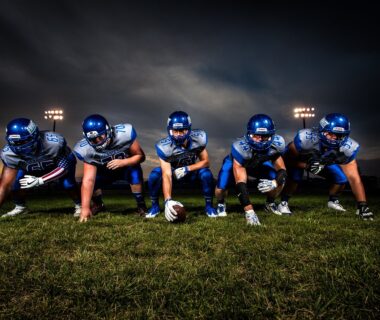 Football team lined up facing camera ready to charge