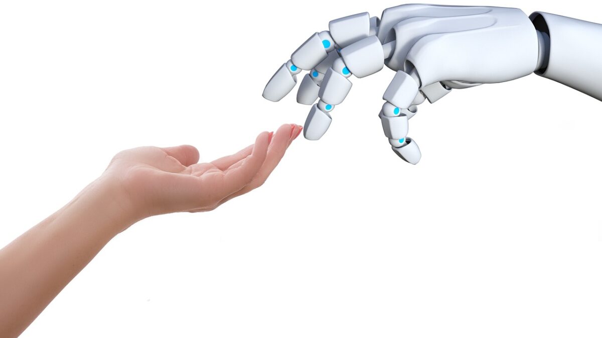 Human hand touching a robot hand