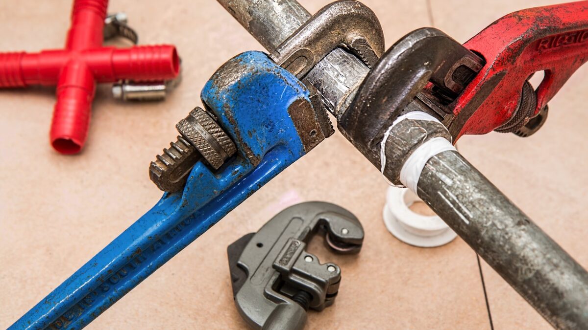 pipe wrenches turning on a pipe