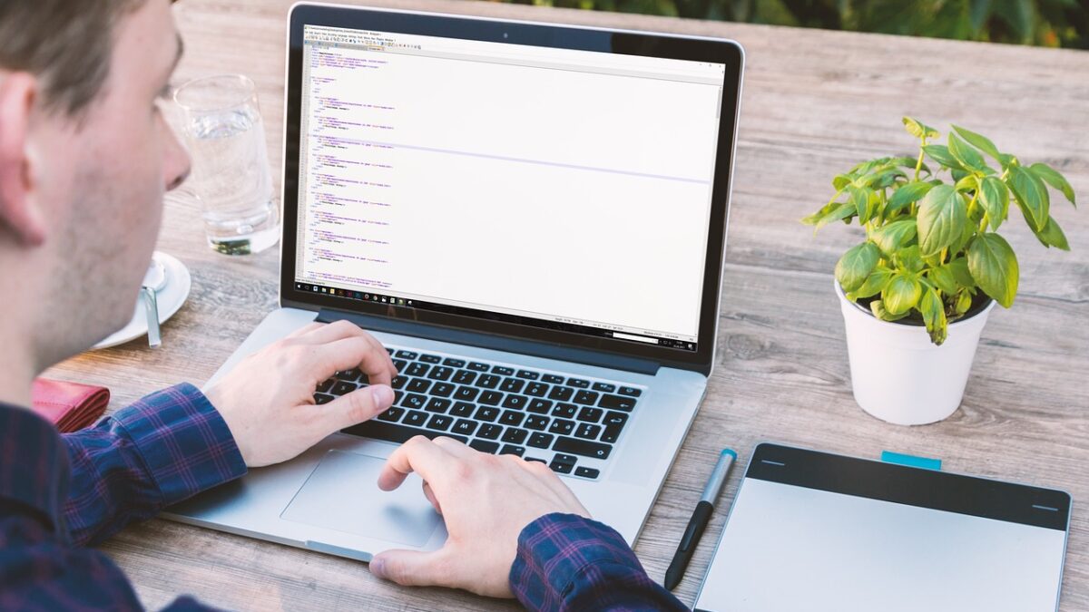 Man using a computer outside